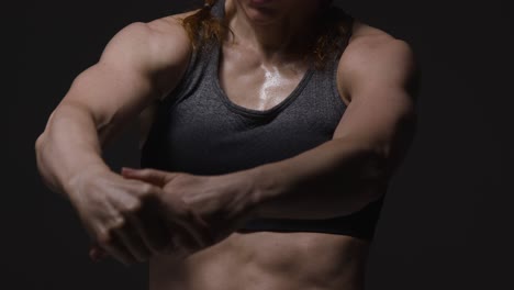 Close-Up-Studio-Shot-Showing-Chest-Of-Mature-Woman-Wearing-Gym-Fitness-Clothing-Doing-Stretching-Exercises