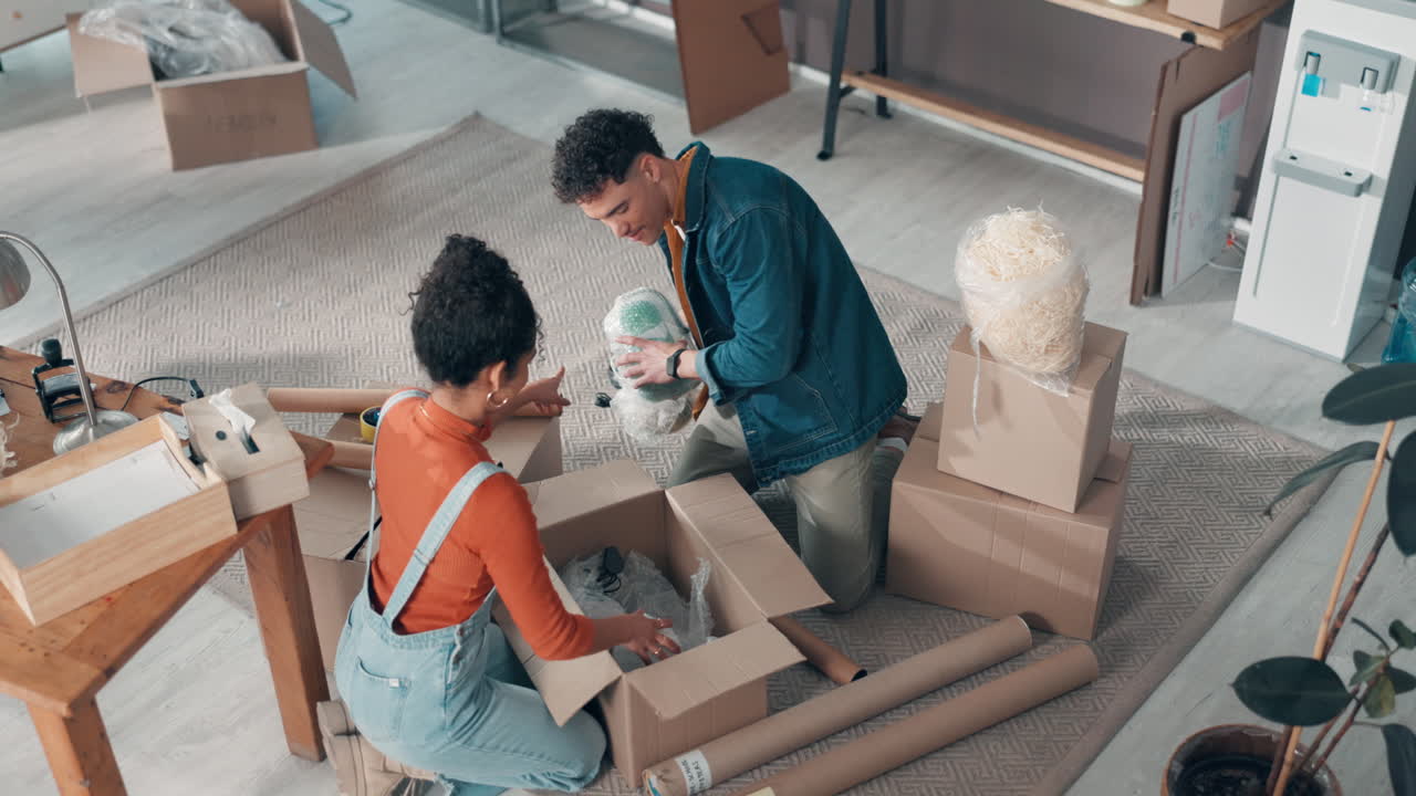 Couple Packing Boxes for Moving