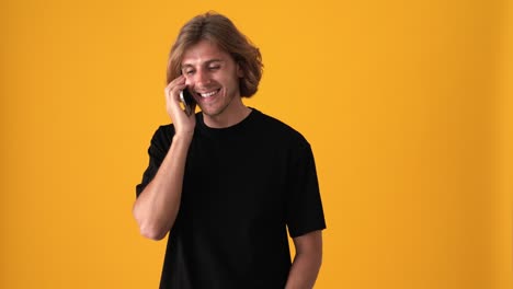 laughing blond man talking by phone