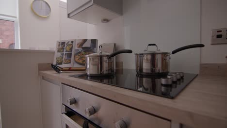 cookbook resting on a kitchen counter next to a hob