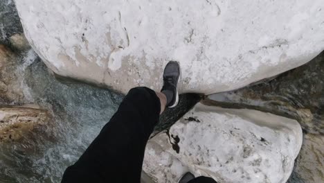 person standing on rocks in a stream