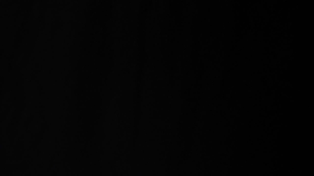 Flying Coffee Beans On Black Background. Roasted Coffee Grains Explosion, Slow Motion