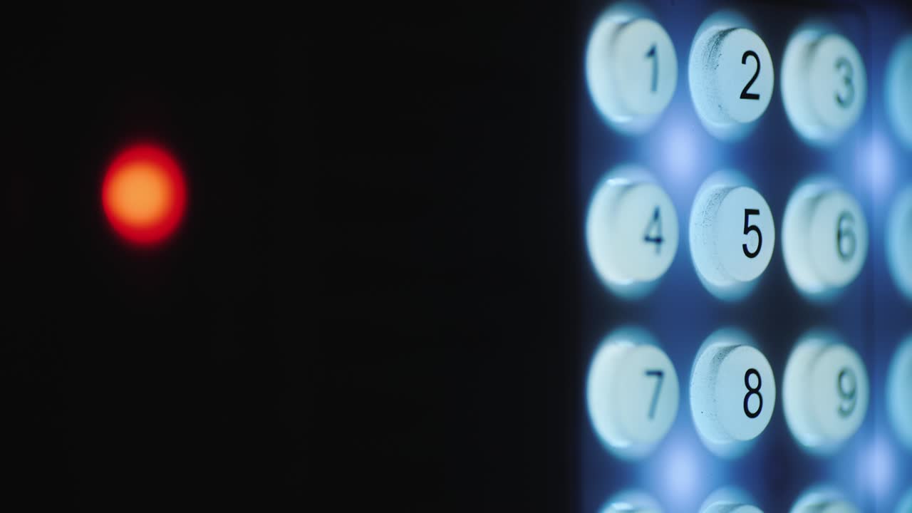 A person enters a pin code on a backlit keyboard