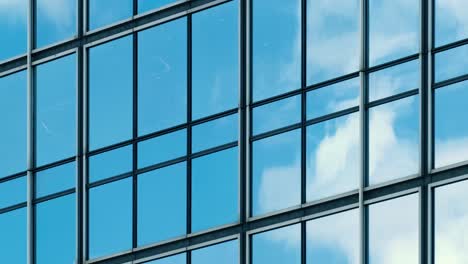 time lapse of blue sky and clouds reflected in structural modular glass wall