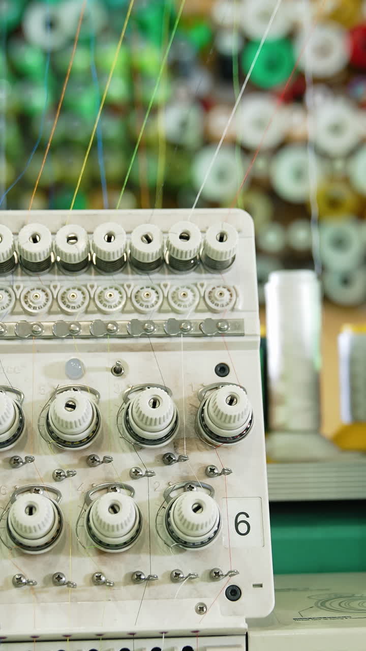 Modern sewing machine full of threads. Awesome factory sewing machine. Vertical video