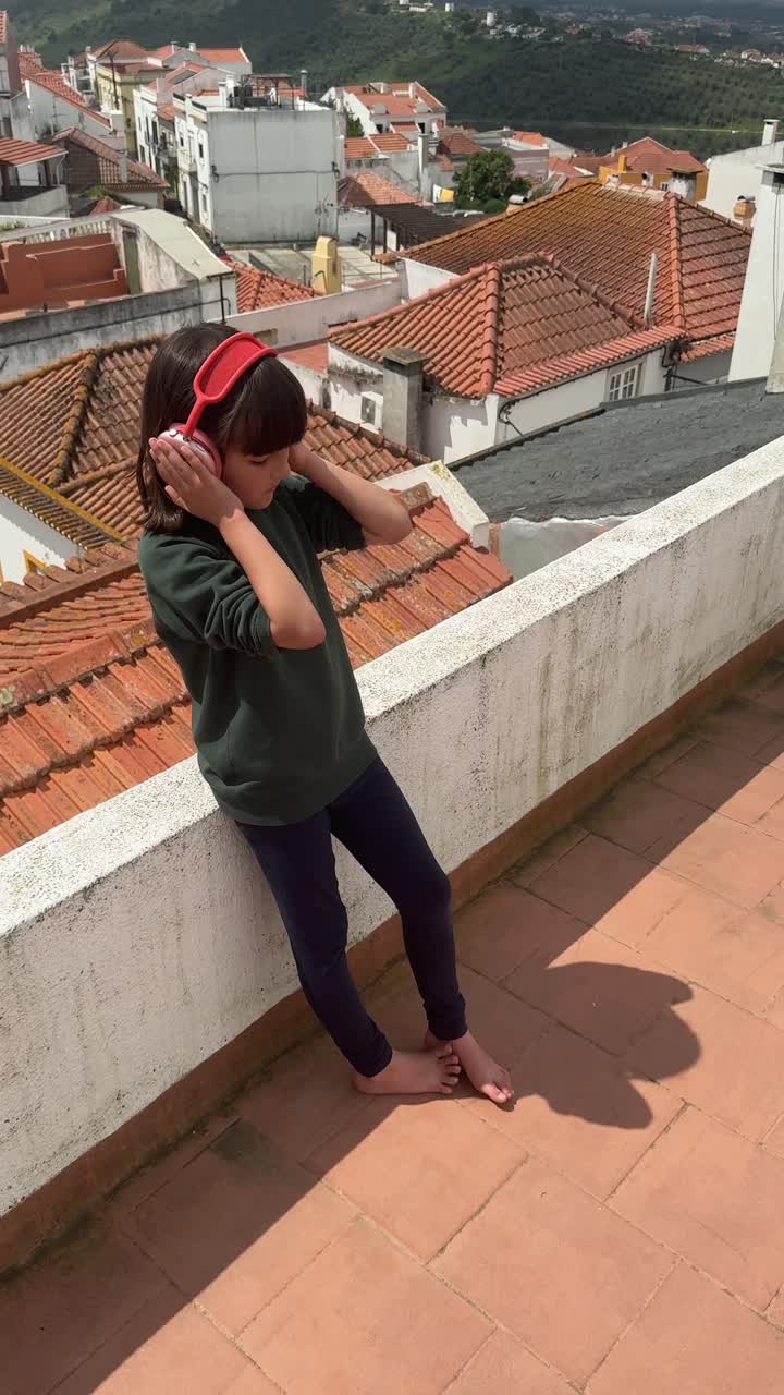 Girl with Headphones on Rooftop