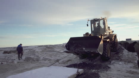 tractor working in snowy terrain