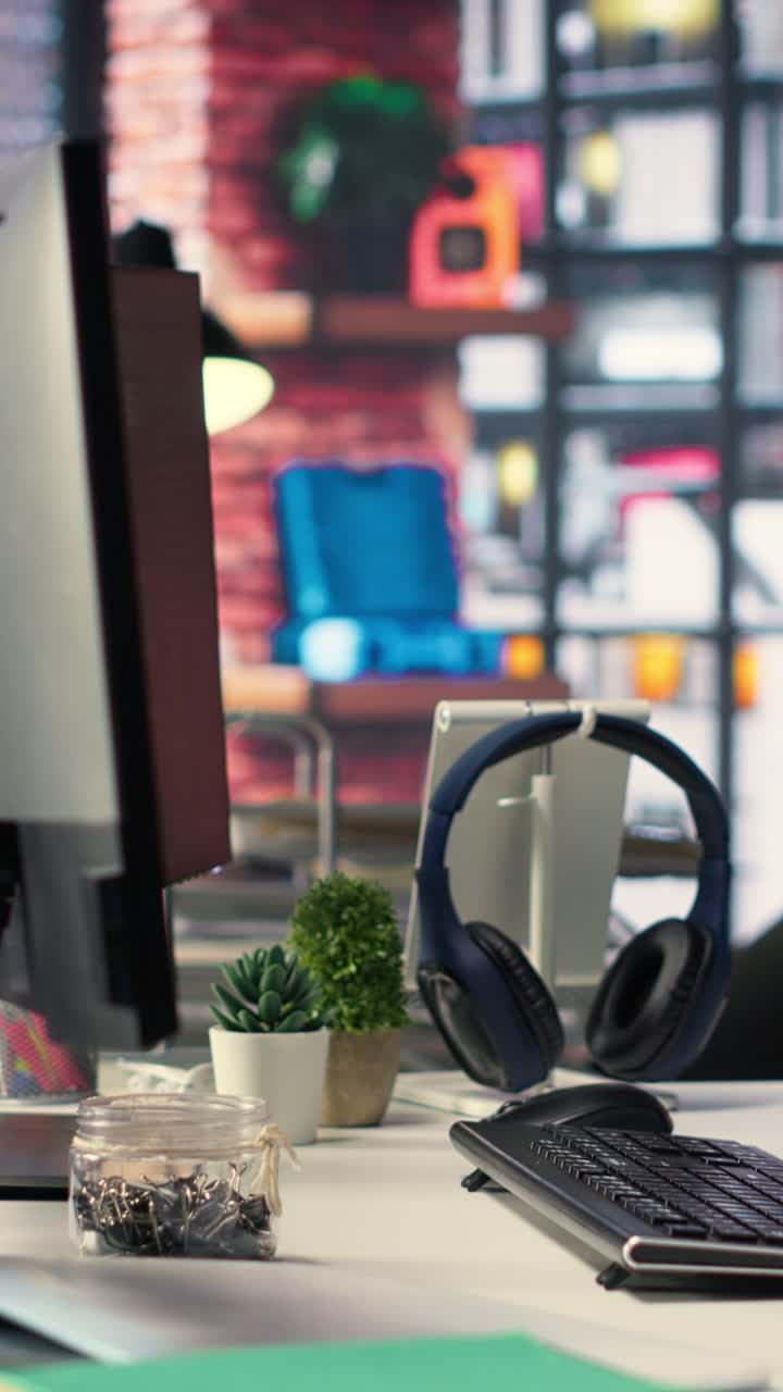 Vertical Video Modern desktop setup in an IT agency shows a visual coding interface