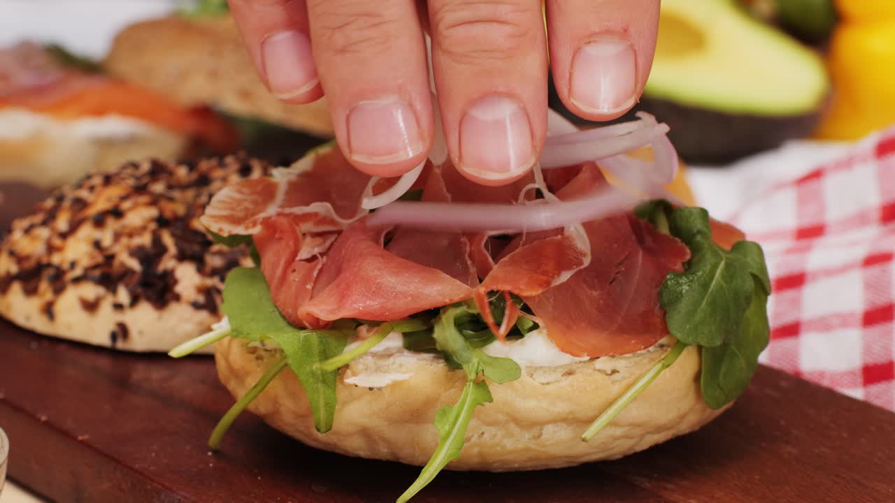 Bagel sandwich brunch, lunch plate of a bagel with smoked salmon and cream cheese and ham, close up morning cafe menu.