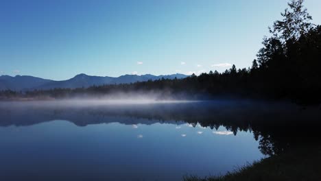 lake shore mist with mountains and forest timelapse enid british columbia canada