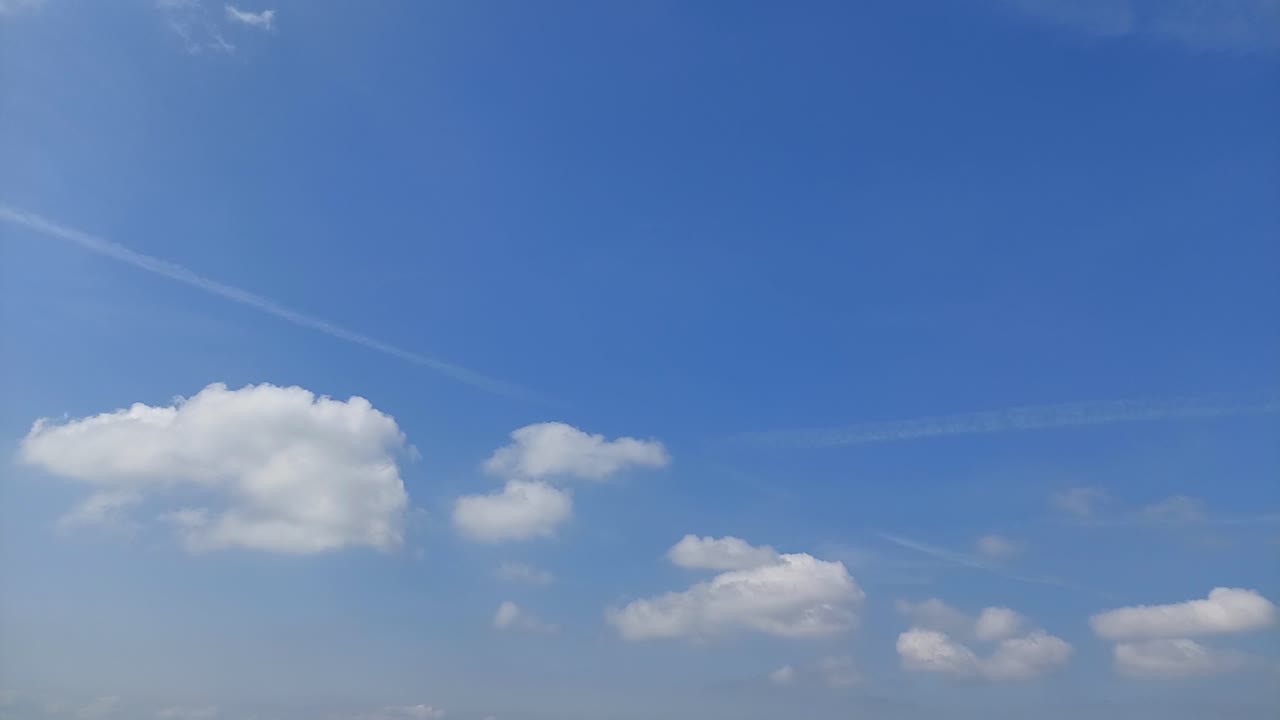 White clouds rolling through a blue sky, pleasant weather, 4k time-lapse video