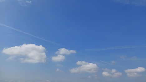 white clouds rolling through a blue sky, pleasant weather, 4k time-lapse video