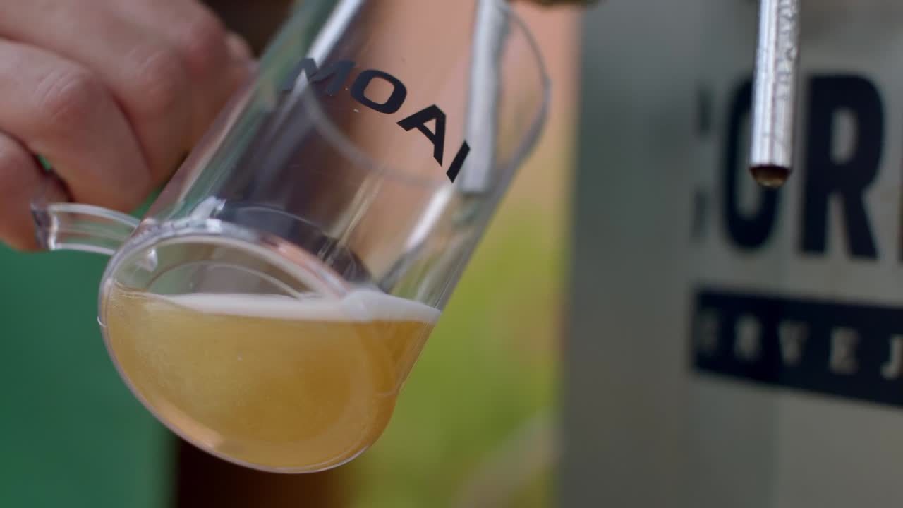 Alcohol on sale and being poured. Refreshments available in events. Slow motion