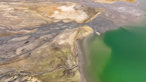 aerial of geological earth formation in konin poland with stunning colorfull lake water