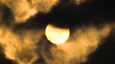 dark clouds crossing the sun, zoom