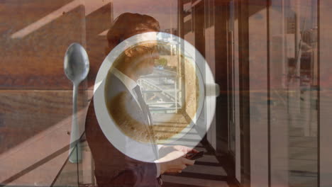 using smartphone, businessman animated coffee cup and spoon on table