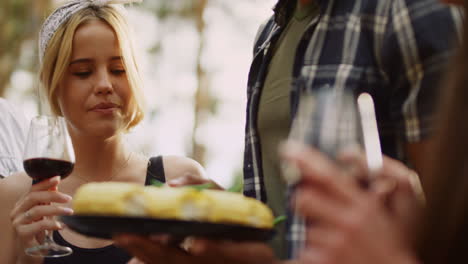 beautiful woman holding glass of wine outdoors. woman taking french bean outside