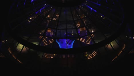 high angle shot over a cruise ship with front indoor pool at night time