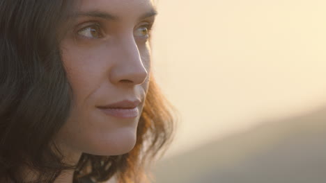 close-up-portrait-of-beautiful-woman-enjoying-peaceful-sunset-exploring-spirituality-looking-up-praying-contemplating-journey-with-wind-blowing-hair