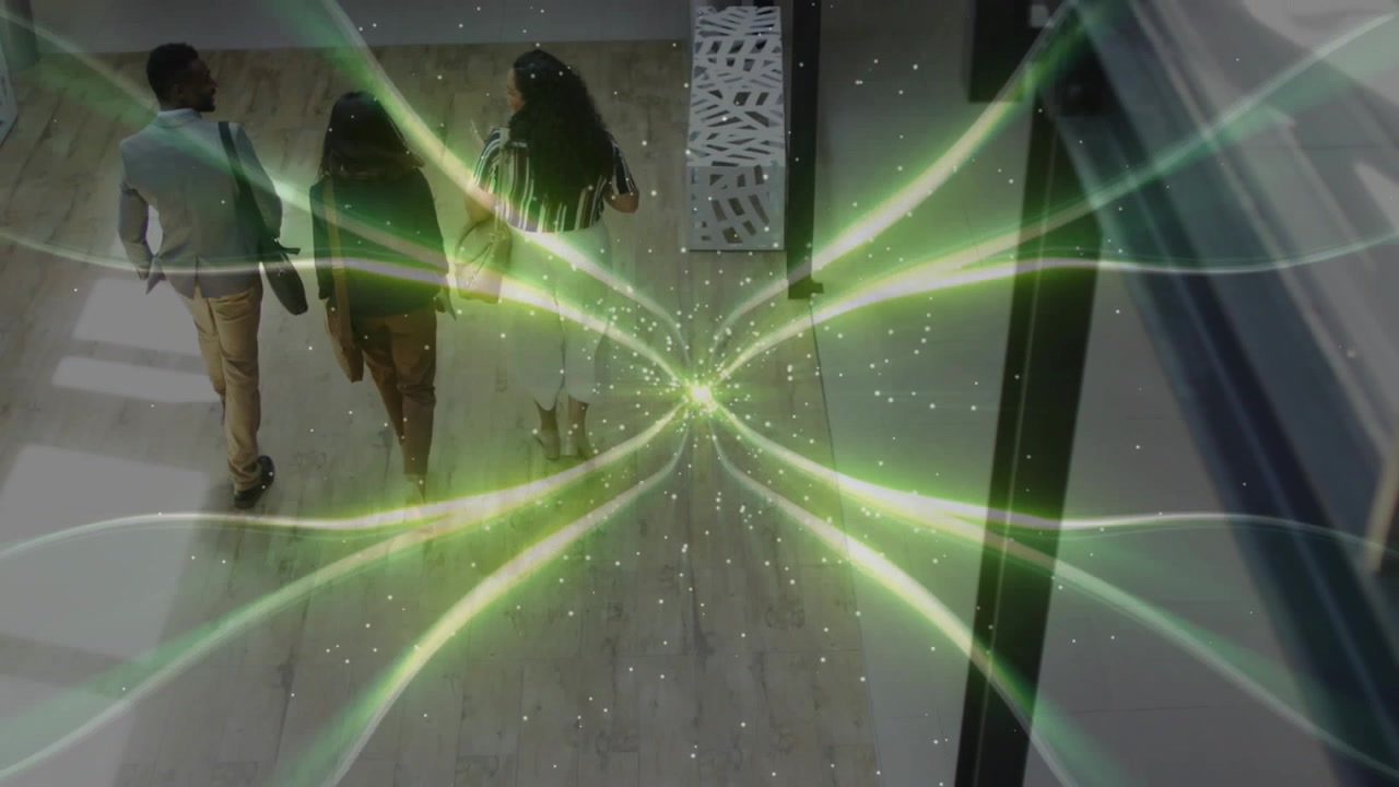 Business team walking into hall discussing project while green fractal overlay pulsing with steps