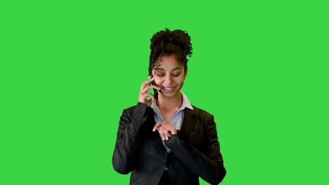happy african american lady walking and talking on the phone on a green screen, chroma key