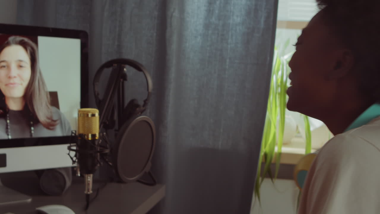 joven negra hablando con amigos en una videollamada en casa