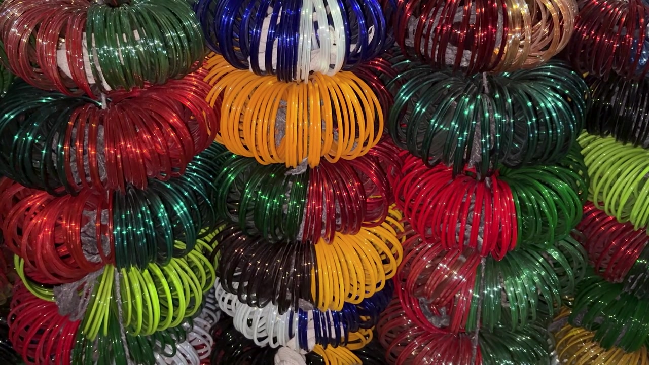 stacked colorful wrist bangles with glossy texture in indian bazaar shop