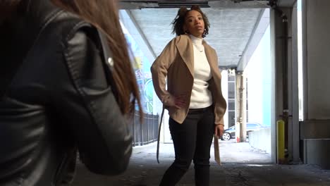 black model poses for a photographer in an alley during a photoshoot