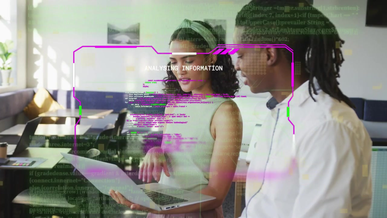 Woman holding laptop guiding colleague using trackpad, initiating purple code HUD for tech review