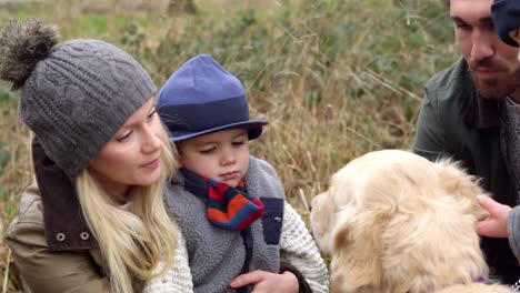 family on winter walk in countryside with dog shot on r3d