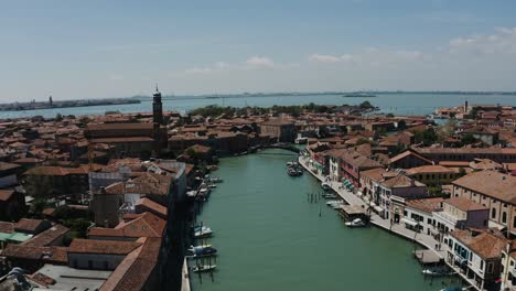 aerial view pulling away from murano, italy's waterways interconnecting the city