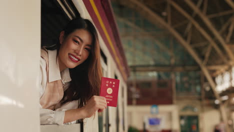 woman with japanese passport at train station