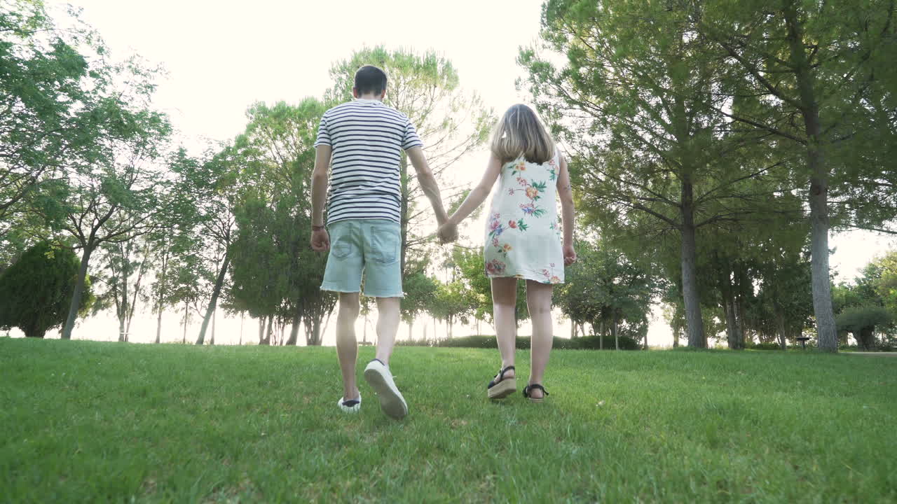 Couple walking in a park holding hands