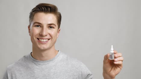 young man holding eye drops