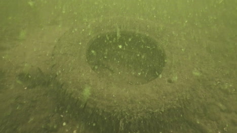 scuba divers clean trash, rubber tires out of a freshwater lake