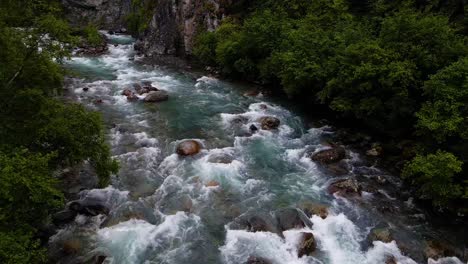 4k aerial drone footage along forested creek and river in alaska during summer