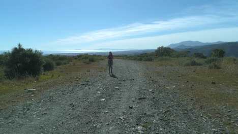 Woman-is-jogging-towards-drone,-capturing-the-front-of-her-body