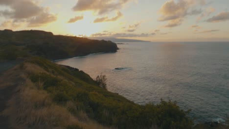 two people standing on the roof of their car watching a sunset in hawaii