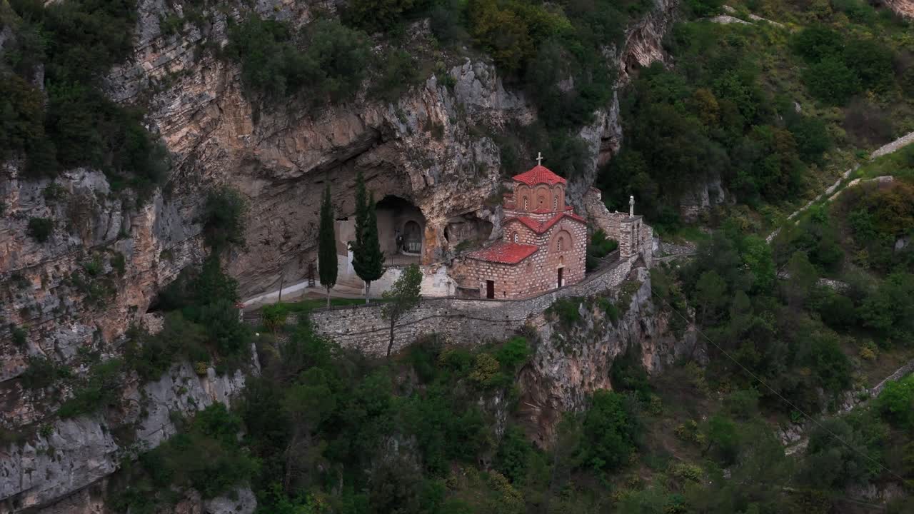 Charming chapel in Berat, Albania, nestled among lush rocky cliffs
