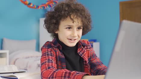 Boy-playing-games-on-laptop-is-excited-and-experiencing-action.