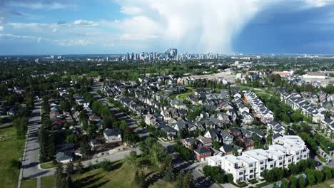 Flying-towards-Calgary-downtown-in-summertime-over-green-communitie