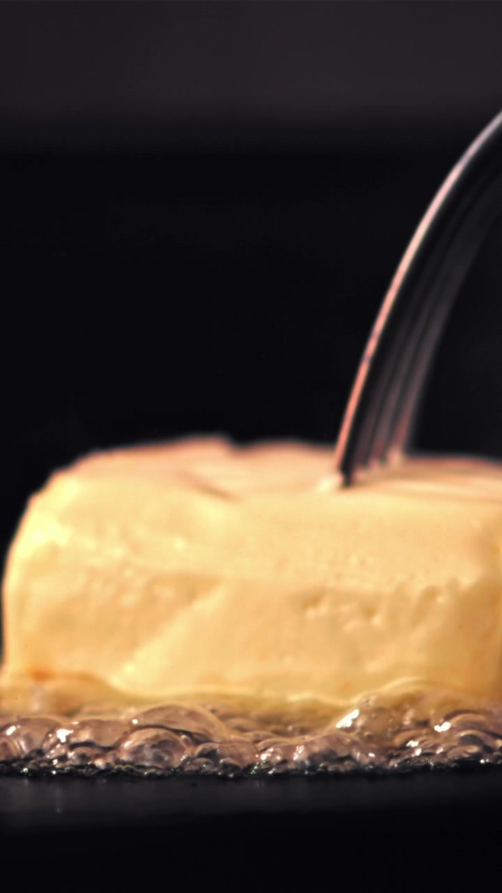 Close-up of Butter Melting and Bubbling in a Hot Pan with a Fork