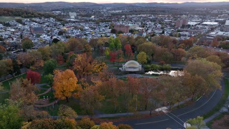 aerial orbit following bend in road through city park