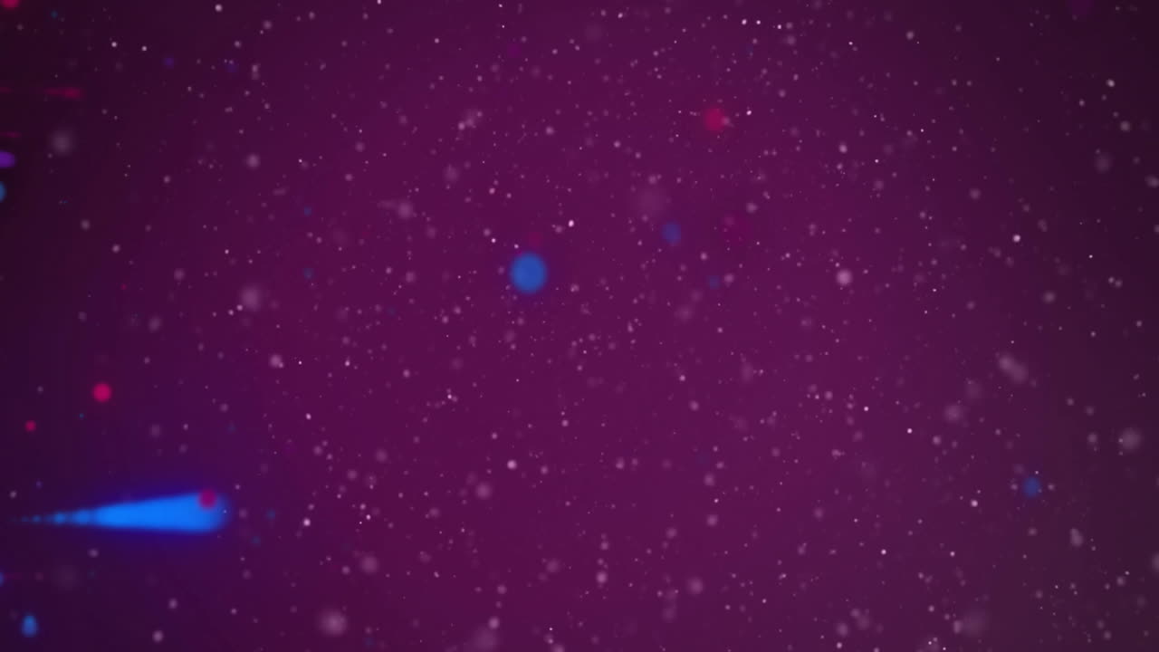 Animation of red and blue light spots moving over white particles on dark background