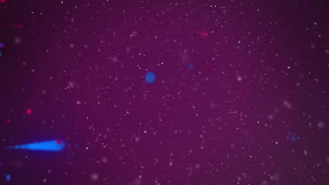 animation of red and blue light spots moving over white particles on dark background