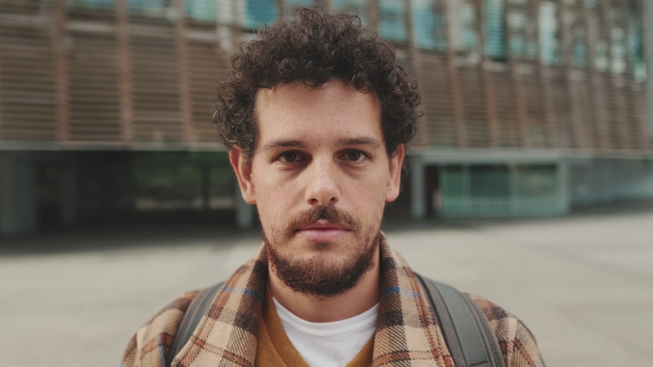 Portrait of a man with curly hair and a beard