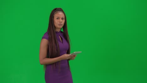 woman presenter on green screen with tablet
