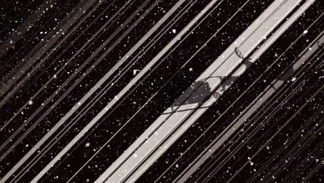 animation of snow falling over santa claus in sleigh with reindeer moving on black background