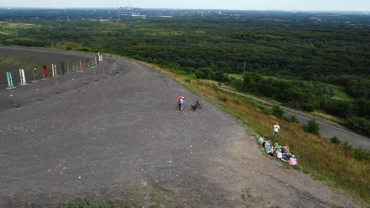 People on a Hill with Art Installation