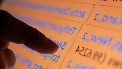 close-up interaction with a touchscreen display, highlighting text content and user engagement in a digital interface